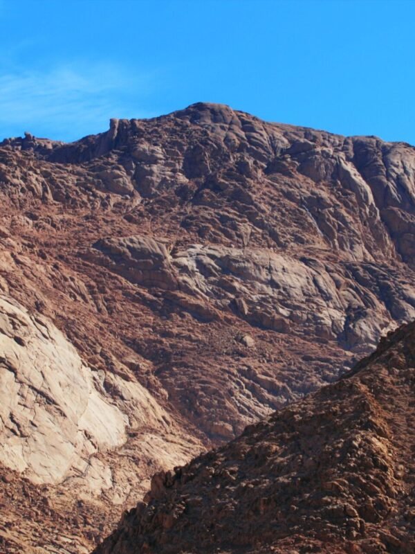 Majestic rocky sinai mountain scene with clear blue sky, perfect for nature lovers and adventurers.