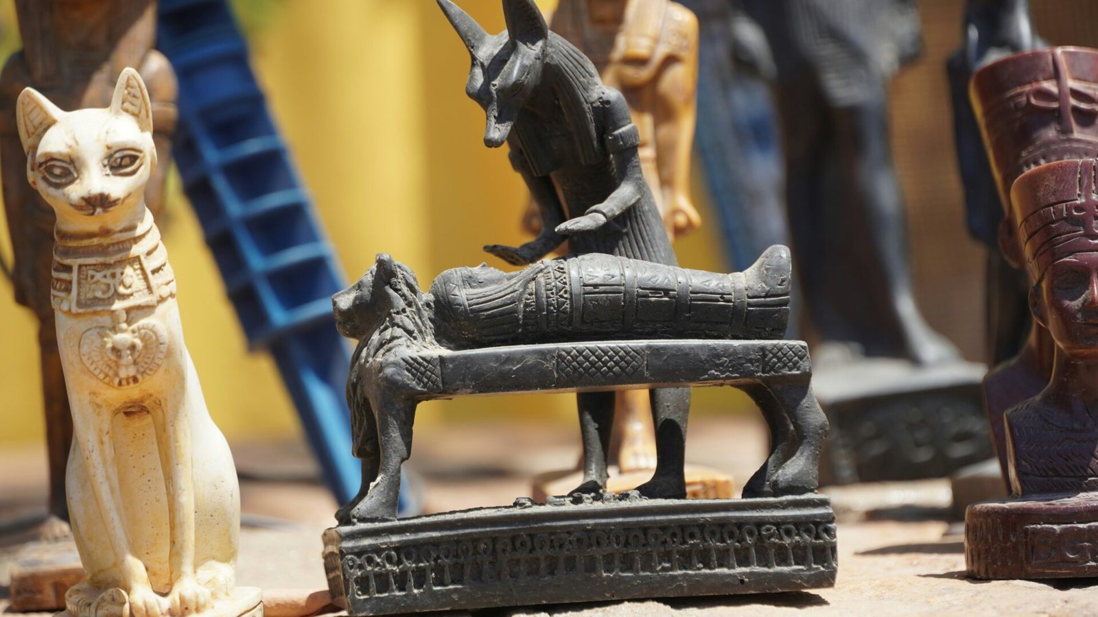 Ancient Egyptian statues displaying traditional attire and jewelry