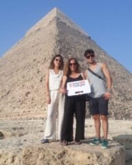 guests holding our sign in front of pyramids 8