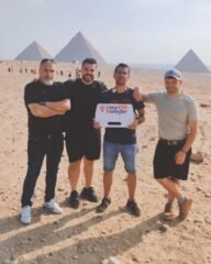 guests holding our sign in front of pyramids 7