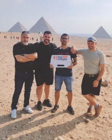 guests holding our sign in front of pyramids 7