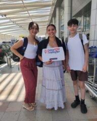 guests holding our sign at the airport