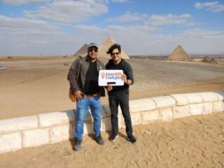 guests holding our sign in front of pyramids 4