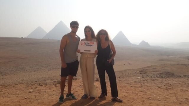 guests holding our sign in front of pyramids 6
