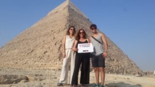 guests holding our sign in front of pyramids 5