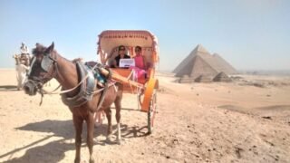 guests holding our sign in a carriage