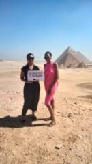 guests holding our sign in front of pyramids 3