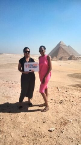 guests holding our sign in front of pyramids 3
