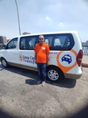 our driver wearing our uniform in front of our van