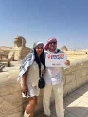 guests holding our sign in front of sphinx